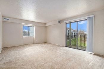 Enlarged living room with a sliding glass door to a balcony and extra window
