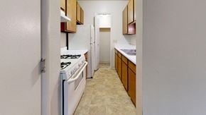 South Bend apartment for rent - a kitchen with a gas stove and a pantry at Irish Hills Apartments, South Bend, IN