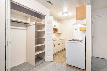 A kitchen with a large closet with shelves