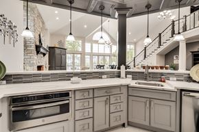 Belleville apartment for rent - A kitchen with a stone wall and a stove top oven at Westlake Apartments, Michigan