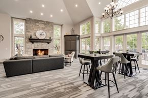 Belleville apartment for rent - A modern dining room with a stone fireplace and a large table set for six at Westlake Apartments, Michigan