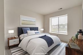 Westland apartment for rent - a bedroom with a bed and two windows at The Landings Apartments, Michigan