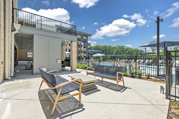 A patio with two chairs and a table.
