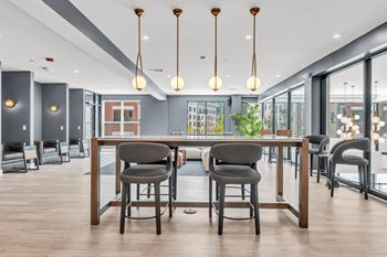 A modern dining area with a long table and chairs.