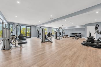 A spacious gym with a variety of equipment.
