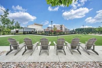A row of chairs are lined up on a patio