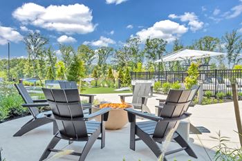A patio with a table and chairs is set up for outdoor dining.