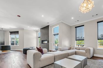 A modern living room with a large sectional sofa and a coffee table.