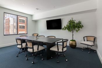 A conference room with a long table and chairs.