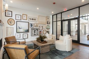 A living room with a brown chair and a plant on the coffee table.