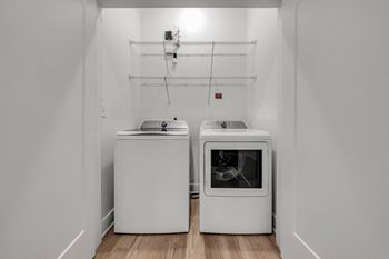 A white kitchen with a dishwasher and an oven.