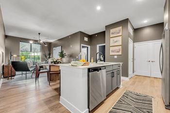 A modern kitchen with a dining table and chairs.