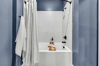 A white bathroom sink with a towel hanging on the wall.