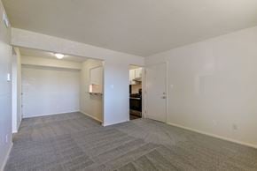 Springfield apartment for rent - A spacious dining room with a carpeted floor and a breakfast bar at Old Monterey Apartments in Springfield, MO
