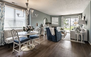 Crown Point apartment for rent - A living room with a white chair set and a blue sofa.