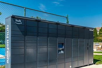 A large amazon hub building is shown with a fence in the background