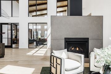 Merrillville apartment for rent - a living room with a white chair and a fireplace