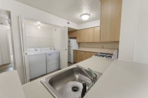 Champaign apartment for rent - a kitchen with washer and dryer at Hunters Pond Apartment Homes, Champaign, IL