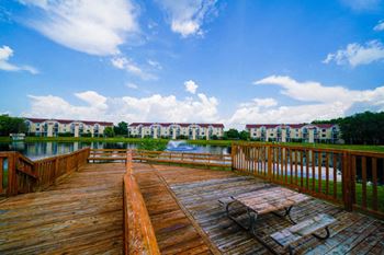 Park-like grounds with picnic tables and pond views