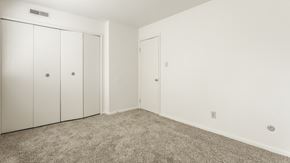 Greenwood apartment for rent - a bedroom with carpet and white walls and doors at Polo Run Apartments, Greenwood