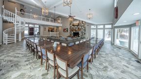 Novi apartment for rent - A large dining room with a long table and chairs at Portsmouth Apartments, 48377