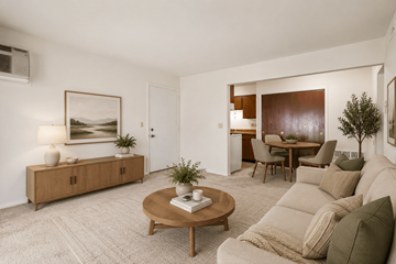 Waterford Twp apartment for rent - A living room with a brown coffee table and a grey couch.