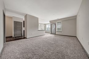 St. Charles apartment for rent - A spacious empty room with carpeted floor and white walls. at River Crossing Apartments, St. Charles, Missouri