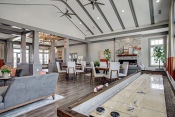 A room with a shiny wooden floor and a pool table.