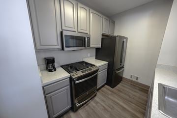 Waterford Twp apartment for rent - A kitchen with a stove, oven, microwave, and refrigerator.