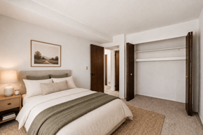 Waterford Twp apartment for rent - A bedroom with a large bed and a painting on the wall.