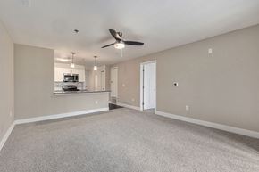 Athens apartment for rent - A spacious living and dining room with a ceiling fan at Signature Pointe Apartment Homes in Athens, AL