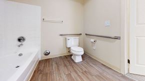 Wyoming apartment for rent - a spacious bathroom with a toilet and a bath tub at Swiss Valley Apartments, Wyoming