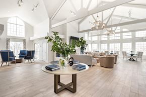 Indianapolis apartment for rent - A spacious room with a round table in the center and chairs surrounding it. at Sundance Apartments, Indianapolis, 46237