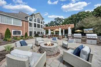 A patio with a fire pit and seating area.