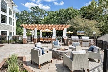 A patio with a fire pit and seating area.