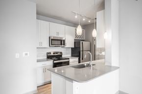Columbus apartment for rent - A modern kitchen with a stainless steel sink and white cabinets.
