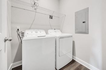 A white washing machine in a small laundry room.