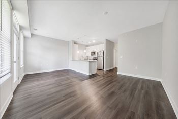 A room with wooden flooring and white walls.