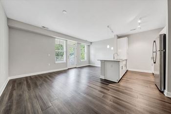 A kitchen area with a refrigerator on the right side.