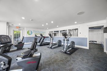 A gym with treadmills and elliptical machines
