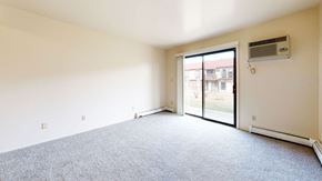 Kenosha apartment for rent - living room with a door to a patio  at Wood Creek Apartments, Kenosha, WI