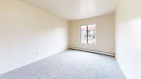 Kenosha apartment for rent - bedroom with carpet and a large window  at Wood Creek Apartments, Wisconsin