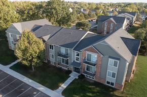 Farmington Hills apartment for rent - A large building with a parking lot in front.