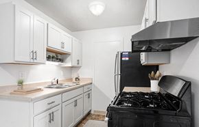 Walker apartment for rent - An upgraded kitchen with white cabinets and stainless steel appliances  at Apple Ridge Apartments, Walker, MI