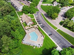 Elkhart apartment for rent - A bird's eye view of a residential area with a swimming pool and a parking lot at Arbor Lakes Apartments in Elkhart, IN