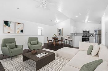 A large empty living room with a ceiling fan