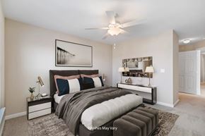 Kennewick apartment for rent - A bedroom with a large bed and a ceiling fan.