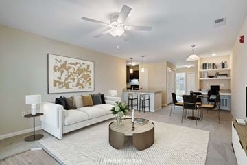 Kennewick apartment for rent - A living room with a white couch, a coffee table, and a painting on the wall.