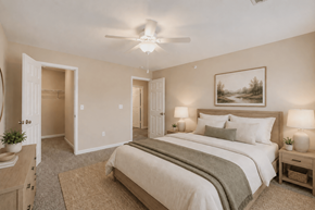 Collierville apartment for rent - A bedroom with a large bed and a painting on the wall.
