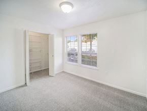 Lincoln apartment for rent - an upgraded bedroom with a walk in closet and a window at Black Sand Apartment Homes in Lincoln, NE